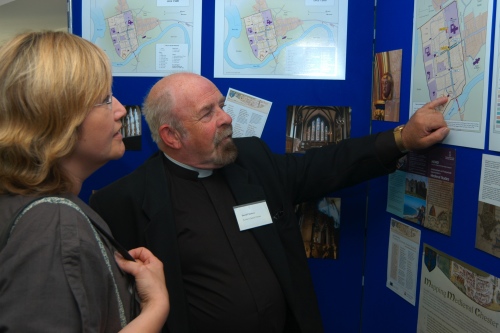 Two participants – Sue Hughes of the Grosvenor Museum, Chester, and Rev David
                Chesters of St John’s Church, Chester – discuss our displays