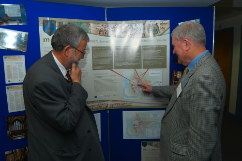 Two delegates, John Law and Ralph Griffiths, discuss the project poster